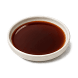 Chinese black vinegar in a low warm off-white ceramic condiment dish on a pure white background.
