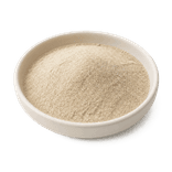 Fine pale-beige ground white pepper in a warm-white ceramic condiment dish