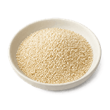 Whole ivory-white sesame seeds in a low warm off-white ceramic condiment dish 